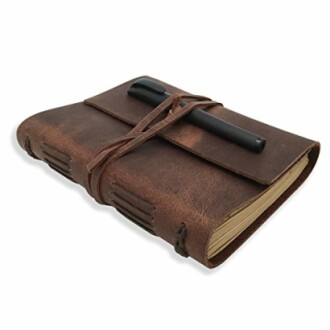 Leather-bound journal with pen tucked under strap