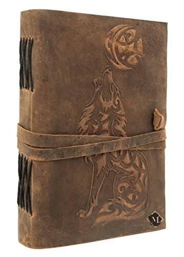 Leather journal with embossed wolf design.