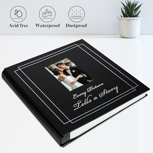 Black photo album on a table with decorative text 'Every Picture Tells a Story' and icons for acid-free, waterproof, and dustproof features.