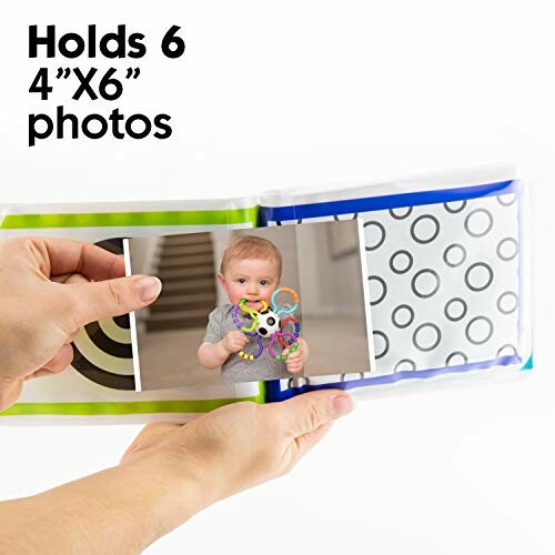 Hands holding a photo album with a baby photo.