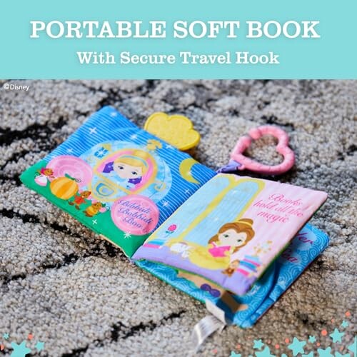 Portable soft book with secure travel hook on fluffy carpet.