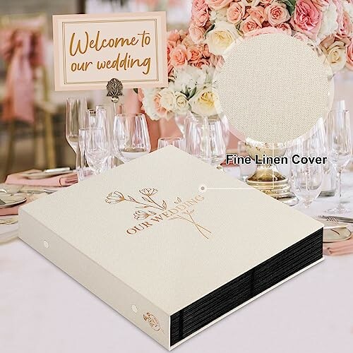 Wedding table setting with flowers and a linen-covered book.