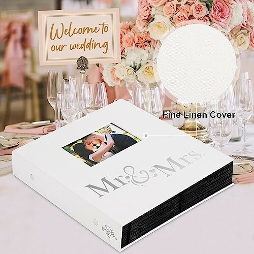 Wedding photo album with fine linen cover on a decorated table.